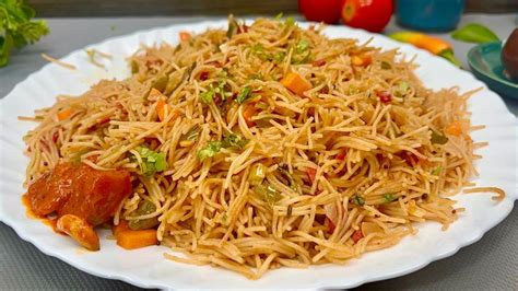 A White Plate Topped With Noodles And Vegetables