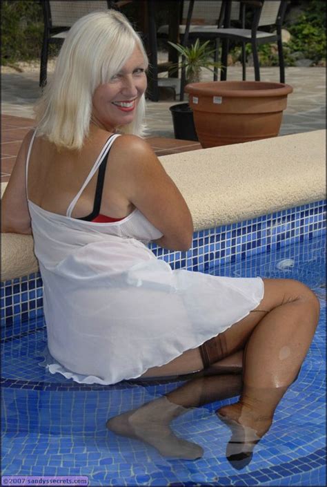 Sandy Spain Takes Off Her Stockings And Shows Her Shaved Pussy In The Pool Porn Pictures XXX