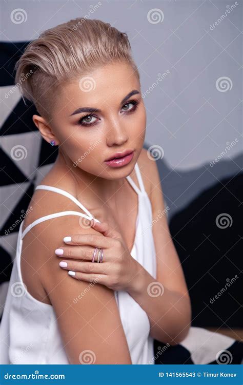 Closeup Portrait Blonde Model With Bright Make Up And Short Hair With Shaved Temples In Modern