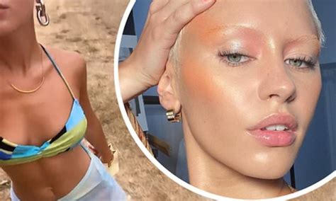 Iris Law displays her enviable figure in a patterned bikini as she takes a solo walk in Kéa