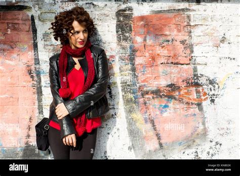 Gorgeous Brunette Woman Posing With Graffiti On The Street Stock Photo Alamy