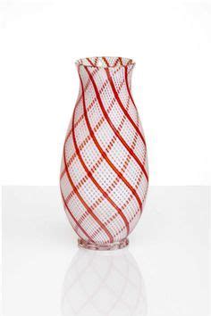 A Red And White Vase Sitting On Top Of A Table