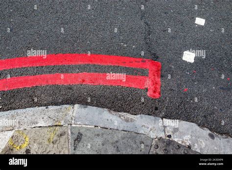 A double red line, signifying a TfL (Transport for London) no-stopping ...