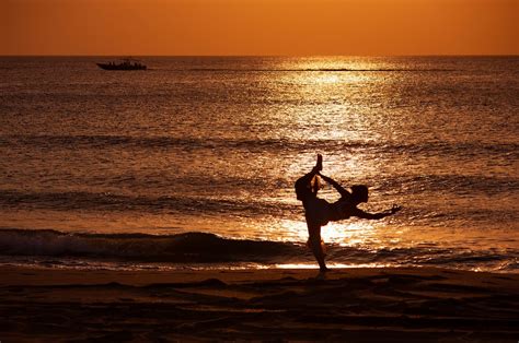 Silhouette of a Woman Doing Yoga at the Beach · Free Stock Photo