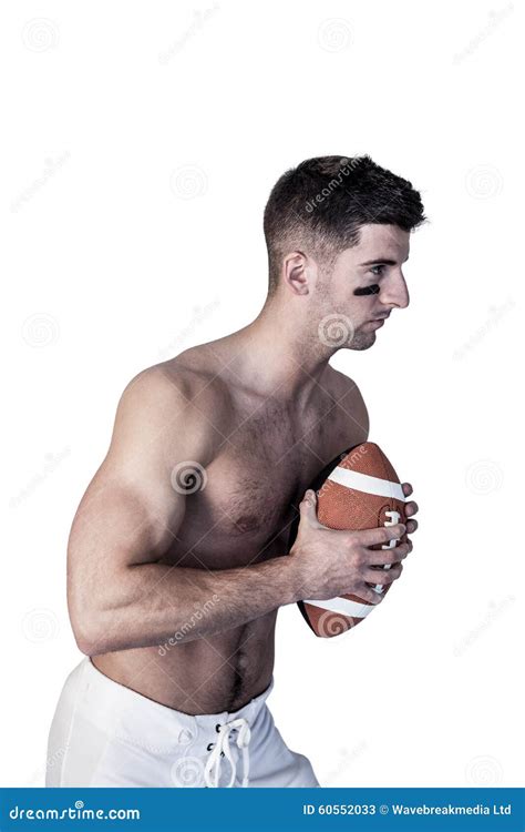 Shirtless Rugby Player Holding The Ball And Focusing Stock Image