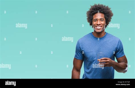 Afro American Man Drinking Glass Of Water Over Isolated Background With