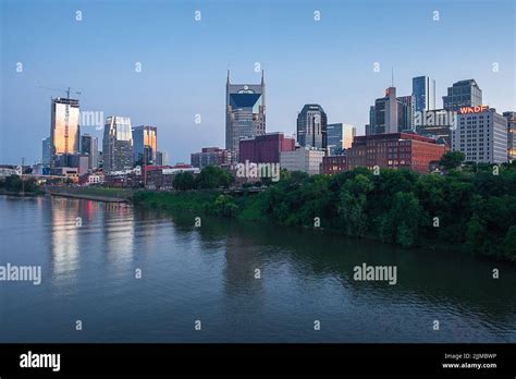 The Nashville, Tennessee skyline over Cumberland River during sunset ...