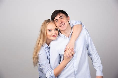 Free Photo Blonde Woman Hugging Brunette Guy Model And Smiling