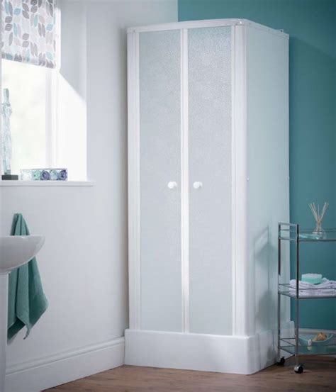 A Bathroom With A Stand Up Shower Next To A White Sink And Mirror On