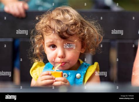 Cute Kid Girl Drinking Juice In Park Stock Photo Alamy