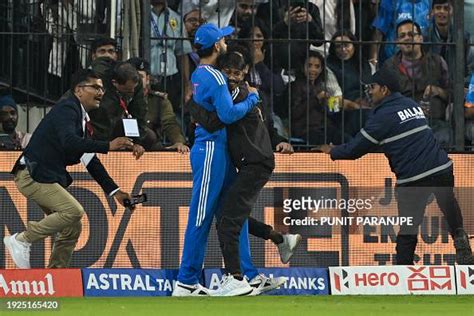 A Pitch Invader Embraces Indias Virat Kohli During The Second News