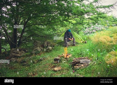 Camping Tent Woods Campfire Man Sharpening Stick Stock Photo Alamy