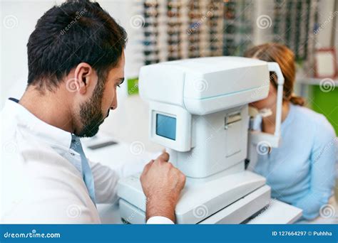 Eye Test Optometrist Testing Woman Eyesight On Modern Equipment Stock