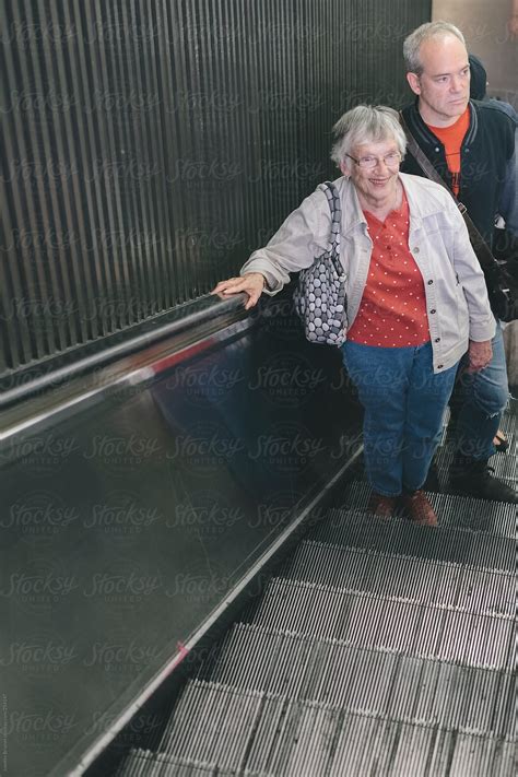 Senior Woman Going Up The Escalator Of New York S Subway