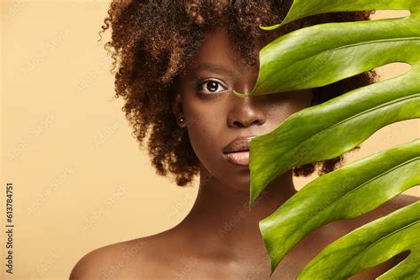 Female Nude Model Of African Ethnicity With Monstera Leaf Stock Photo Adobe Stock