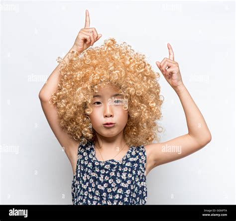 Wearing A Blonde Wig And Funny Facial Expression Asian Girl Stock Photo Alamy