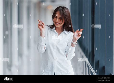 Brunette In White Shirt Posing Indoors In Modern Airport Or Hallway At Daytime Stock Photo Alamy