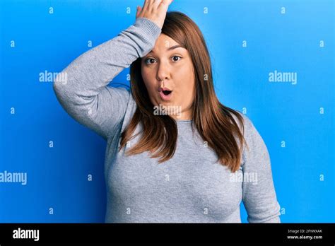 Beautiful Brunette Plus Size Woman Wearing Casual Clothes Surprised With Hand On Head For