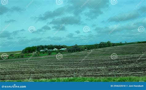 Driving Through The Countryside With Farm Land On The Side Of The Road