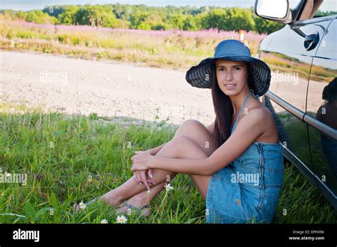 Happy Brunette Woman Sitting Near Car Stock Photo Alamy
