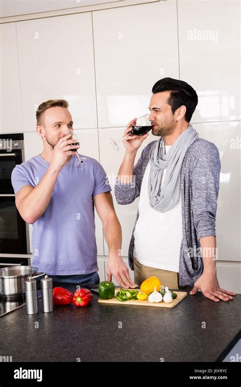 Smiling Gay Drinking Red Wine Stock Photo Alamy