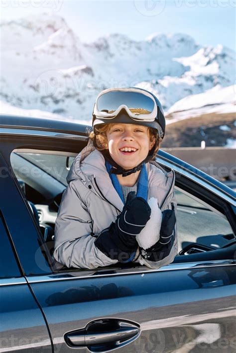 Cheerful boy leaning out window of car on winter day 58543920 Stock