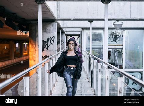 Latina Girl With Long Hair Glasses Brunette Fur Jacket Ripped Jeans Pierced Lip Walking On The