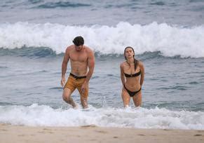 Hemsworth Shows Off His Ripped Beach Bod During A Morning Swim With Bikini Clad Girlfriend