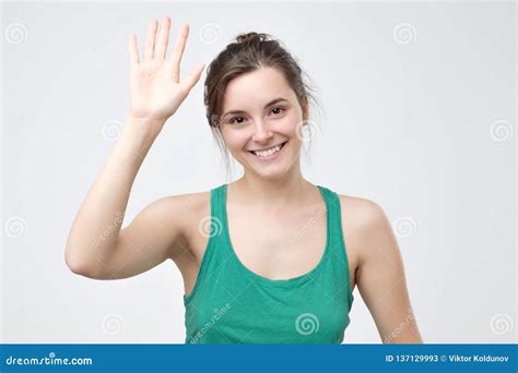 Pretty Student Girl Saying Hello Smiling Joyfully And Friendly Waving