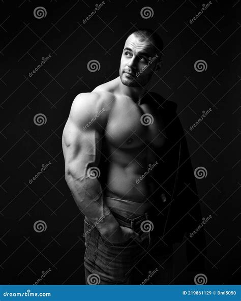 Handsome Pumped Up Brutal Man With Naked Upper Body In Jeans And Underwear Standing Showing