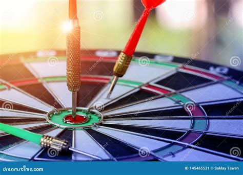 Right On Target Concept Using Dart In The Bulls Eye On Dartboard Stock