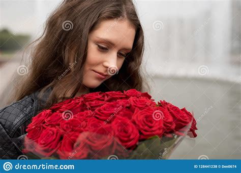 Brunette Girl With A Bouquet Of Red Roses Stock Photo Image Of Cheerful Happy