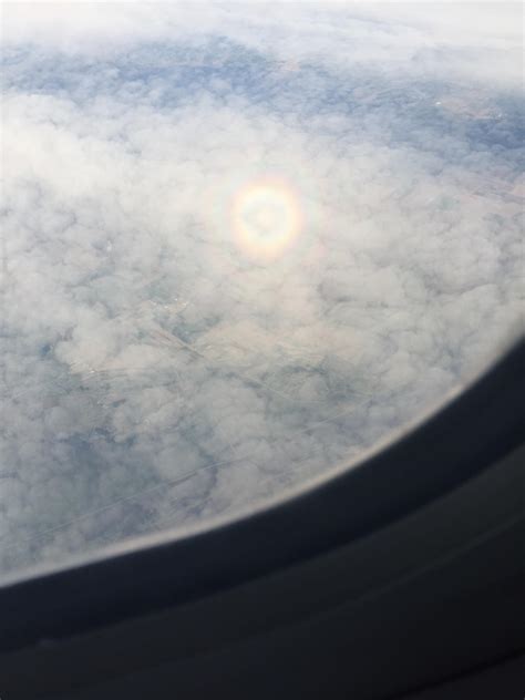 A tiny circular rainbow formed above the clouds : r/mildlyinteresting