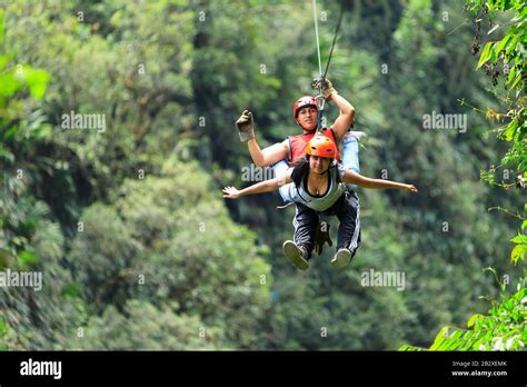 Hispanic Couple Tandem Zipline Stock Photo Alamy