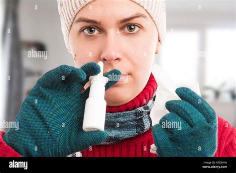 Cold Woman Using Nasal Spray At Home As Flu Or Influenza Concept And