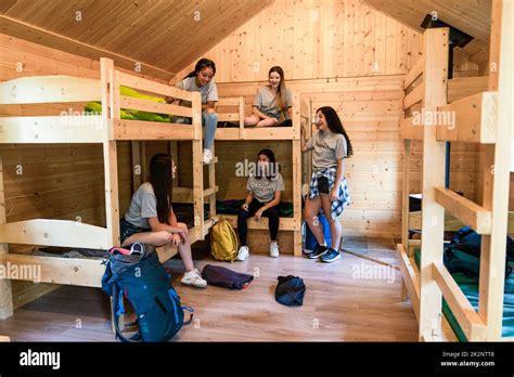 Girls relaxing in dormitory cabin at summer camp Stock Photo - Alamy