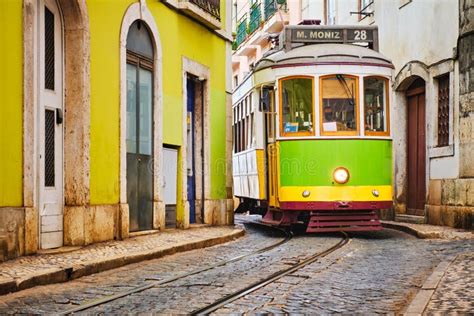 Famous Vintage Yellow Tram 28 in the Narrow Streets of Alfama District in Lisbon, Portugal Stock ...