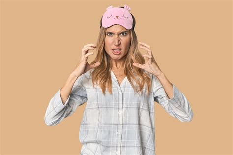Premium Photo Blonde In Pajamas With Sleep Mask Screaming With Rage