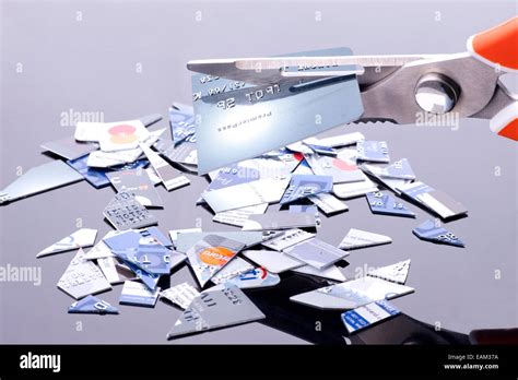 The Act Of Cutting Up Credit Cards For Financial Freedom Stock Photo