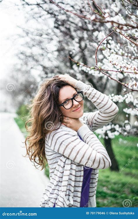 Portrait Of Smiling Caucasian Brunette Woman In Spring Stock Photo