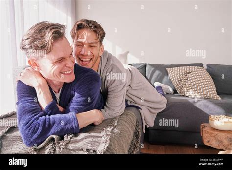 Happy Gay Couple Relaxing On Sofa Stock Photo Alamy