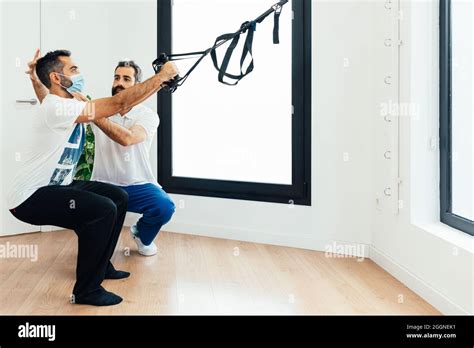 Man Doing Rehabilitation Exercises With A Personal Trainer Health Concept Two People Stock