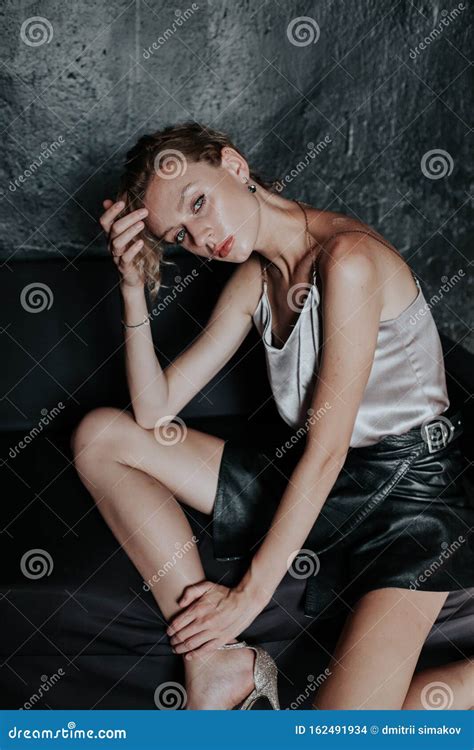 Portrait Of A Beautiful Fashionable Blonde Woman In A Black Skirt Stock Photo Image Of