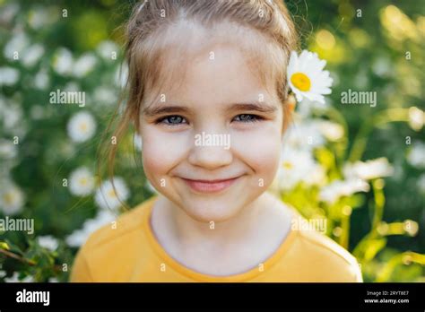Child Portrait Of Cute Little Blue Eyed Girl With Flower Of Chamomile