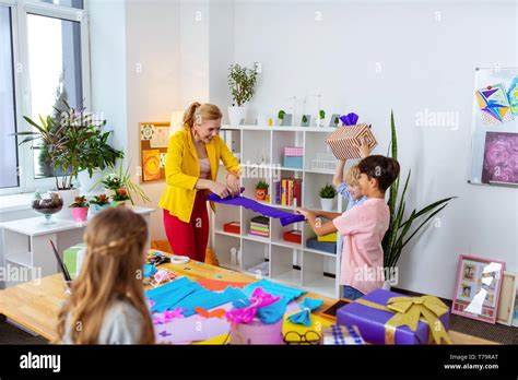 Rolling Colorful Paper Blonde Teacher And Schoolboy Rolling Colorful Paper After Nice Art