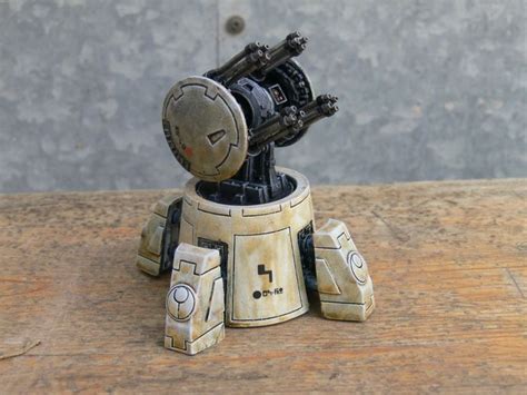 A Small Toy Robot Sitting On Top Of A Wooden Table