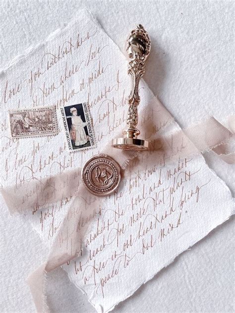 An Antique Key Stamp And Postage Are Laying On Top Of Some Old Letter