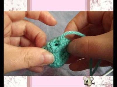 Someone Crocheting A Small Green Piece Of Yarn