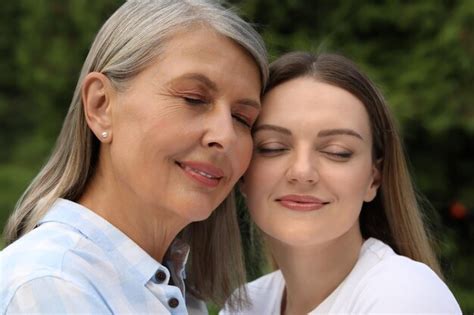Premium Photo Happy Mature Mother And Her Daughter Outdoors
