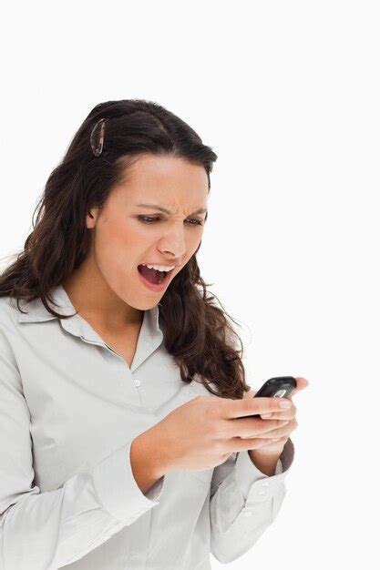 Premium Photo Brunette Frowning While Using Her Mobile